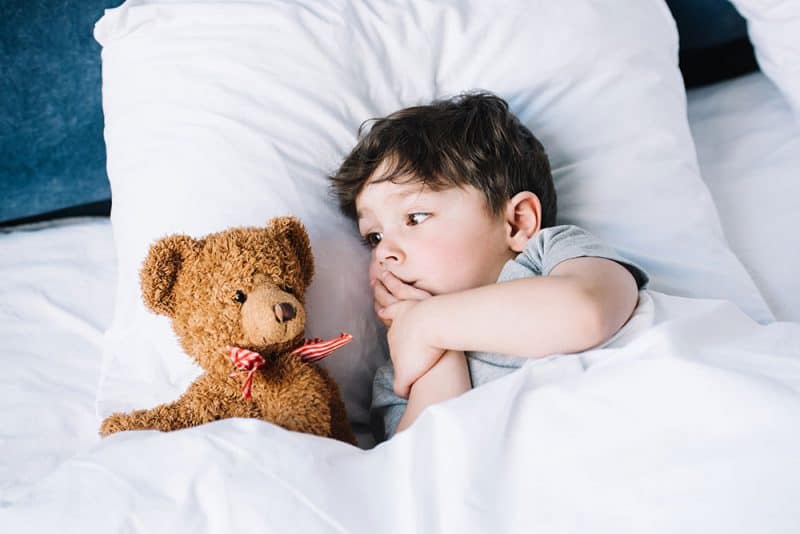 Toddler tucked into bed
