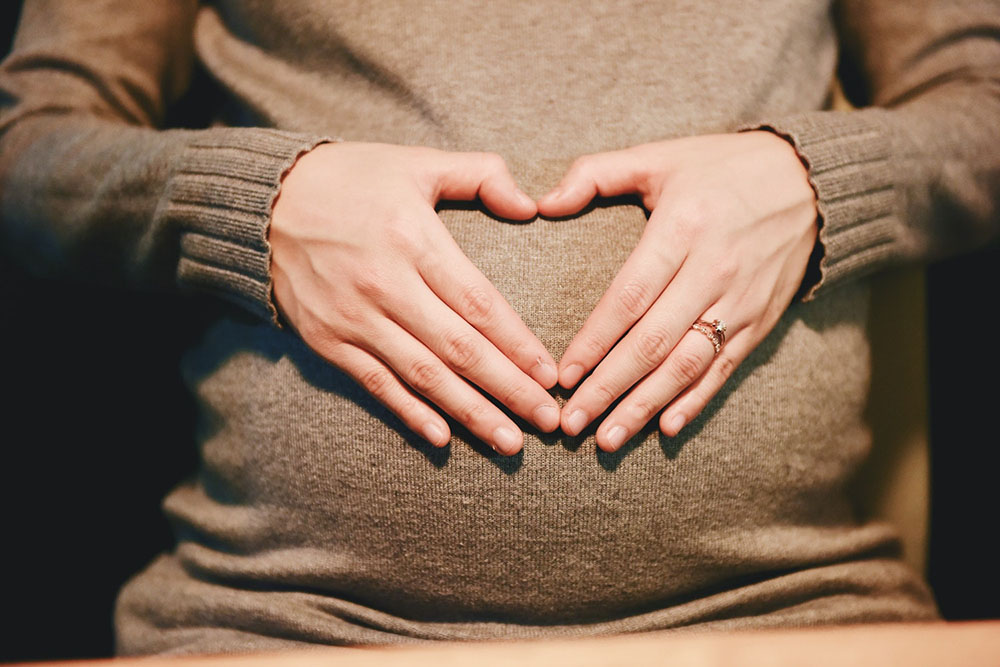 pregnant woman with hands on belly