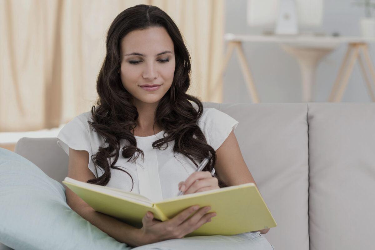 woman writing in notebook