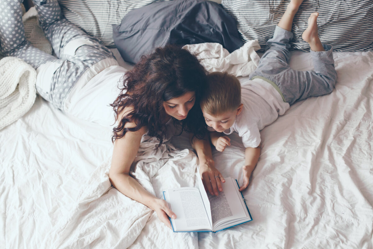 mom and toddler reading together