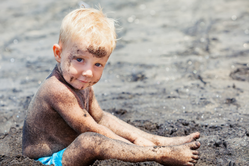 toddler boy playing in dirt