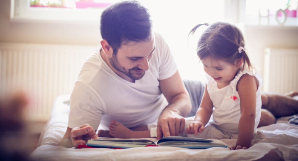 bedtime story between dad and daughter