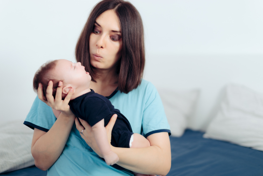 unsure new mom holding newborn