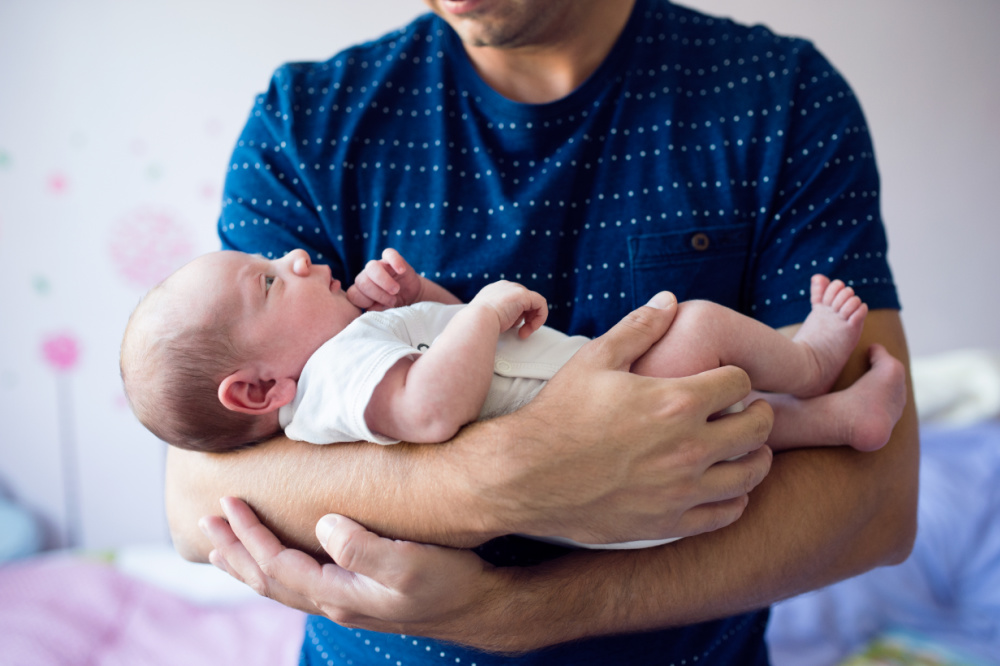 dad holding newborn baby
