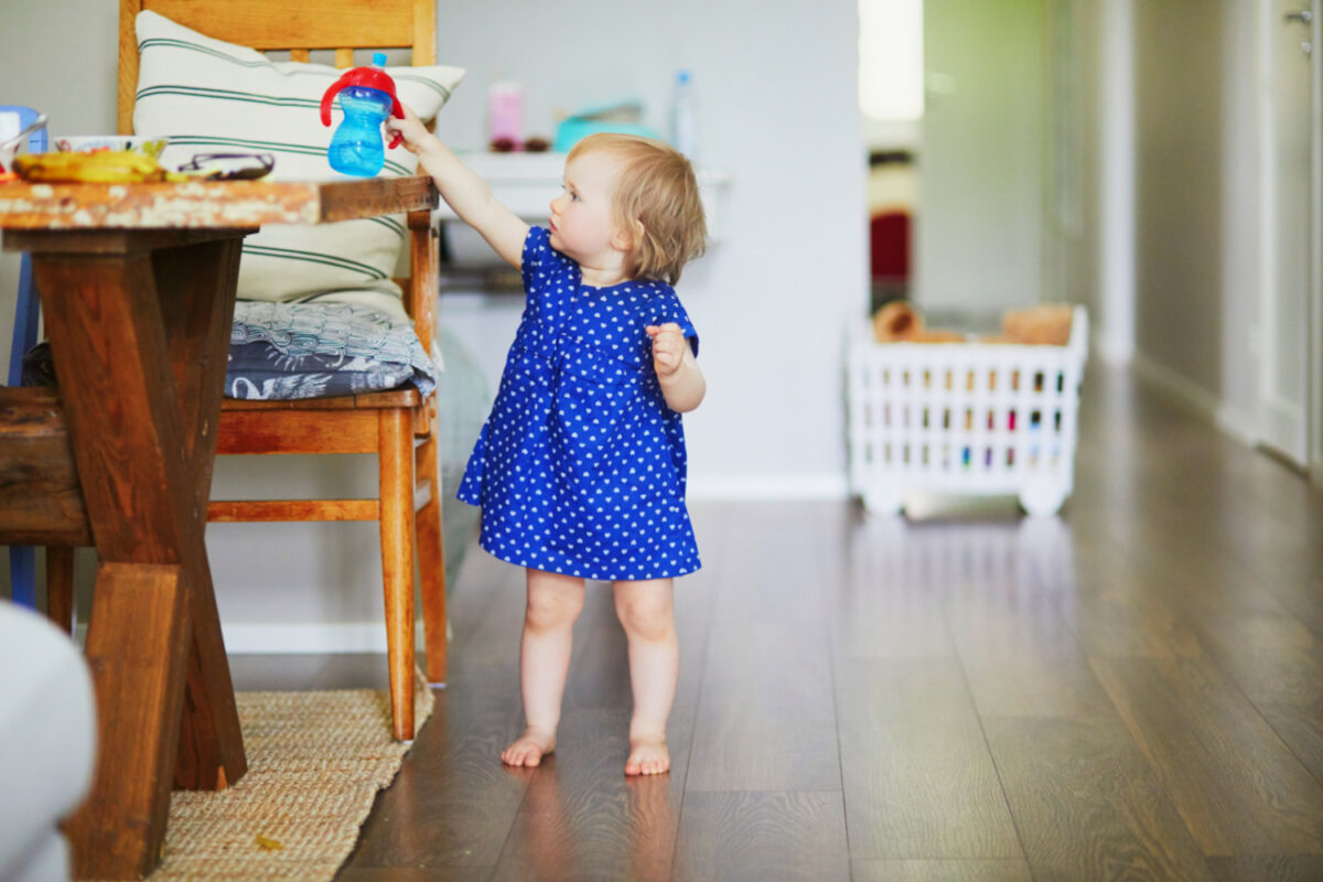 toddler reaching for sippy cup