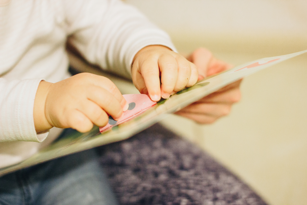 toddler playing with stickers
