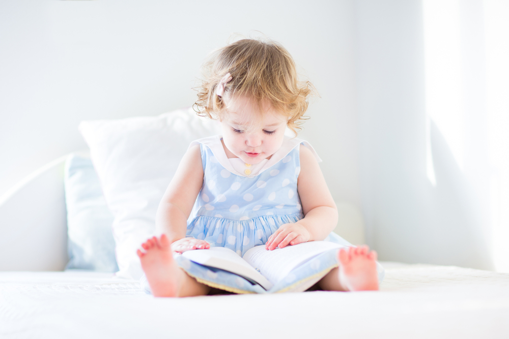 toddler reading a book