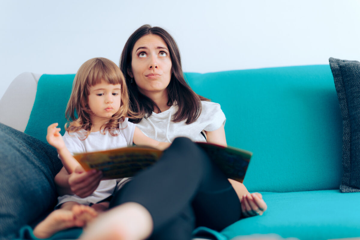 mom reading to child and thinking