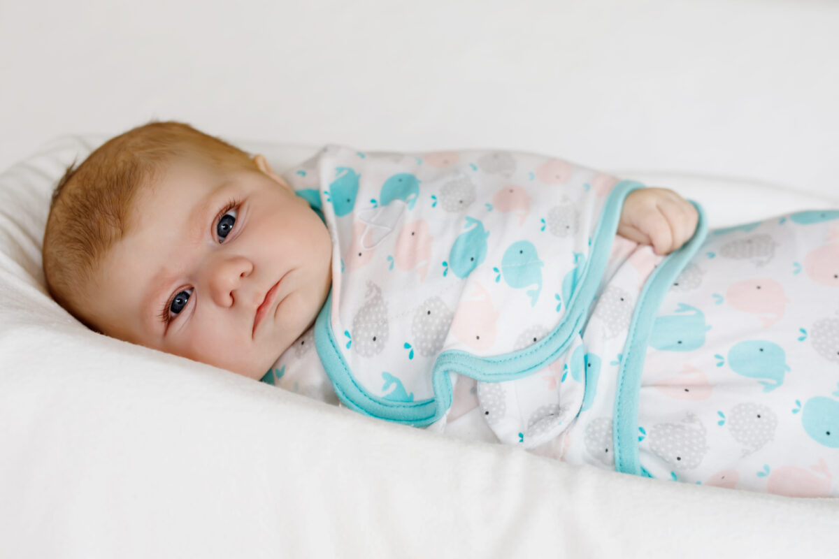 cute baby swaddled in velcro swaddle blanket