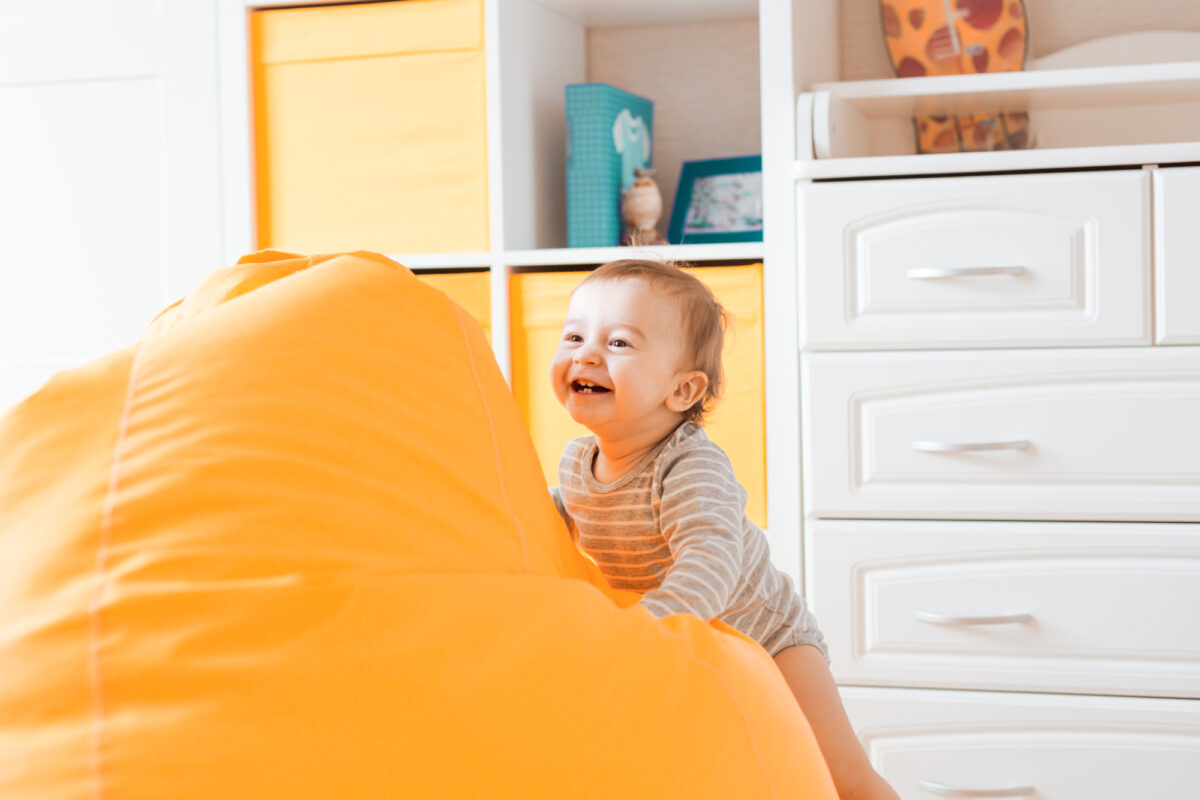 toddler playing on bean bag