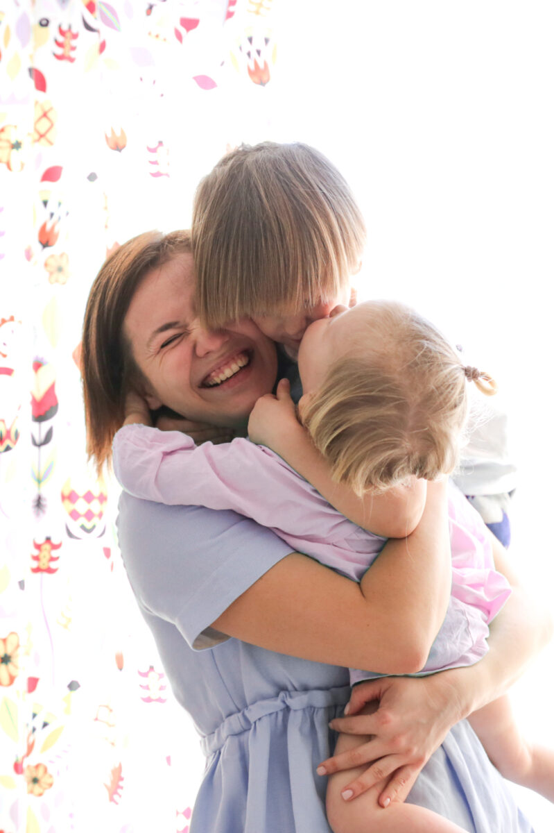 mom hugging children