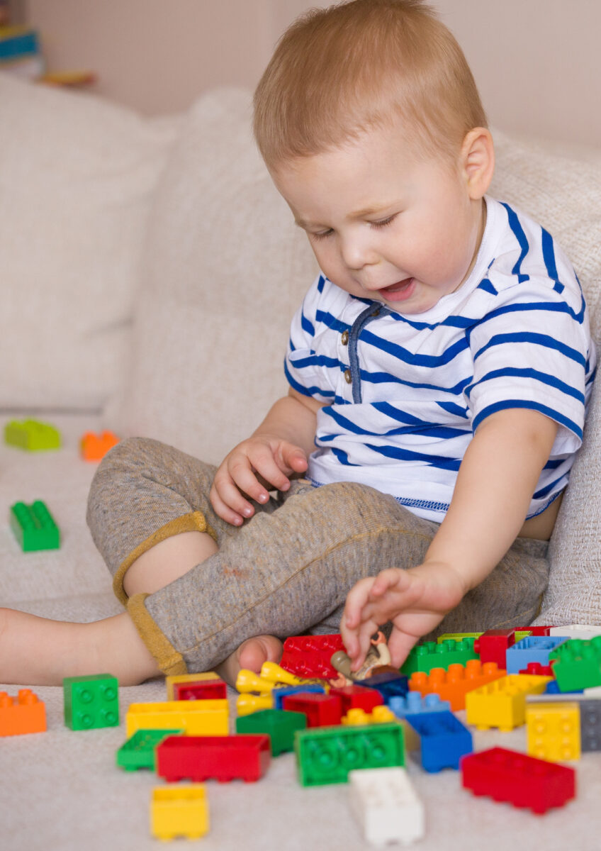 toddler playing with building blocks