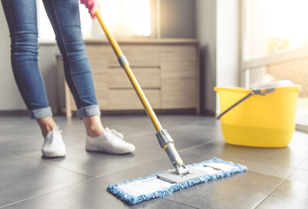 woman mopping dirty floor