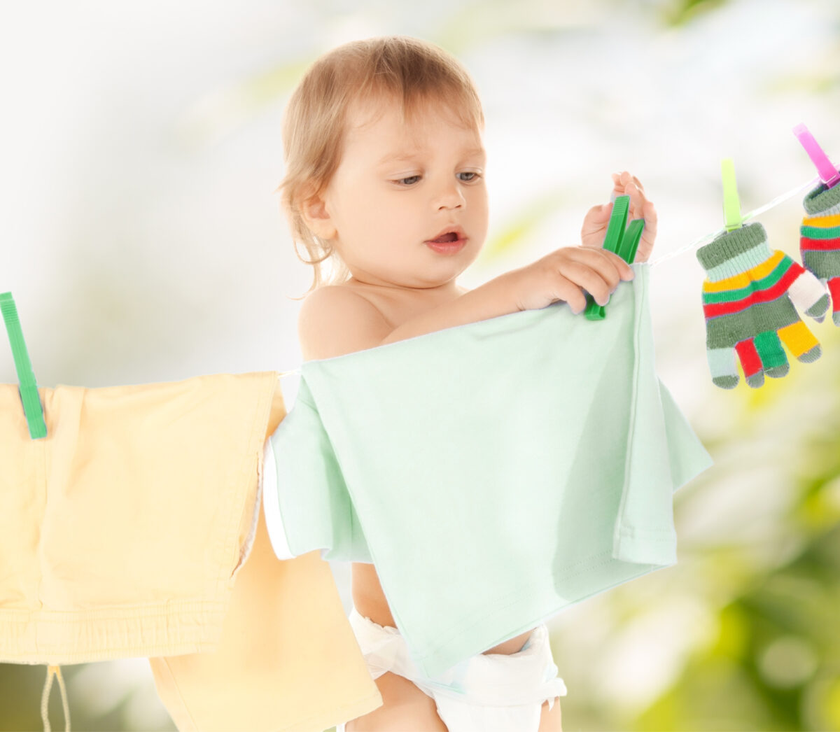 Toddler hanging washing up