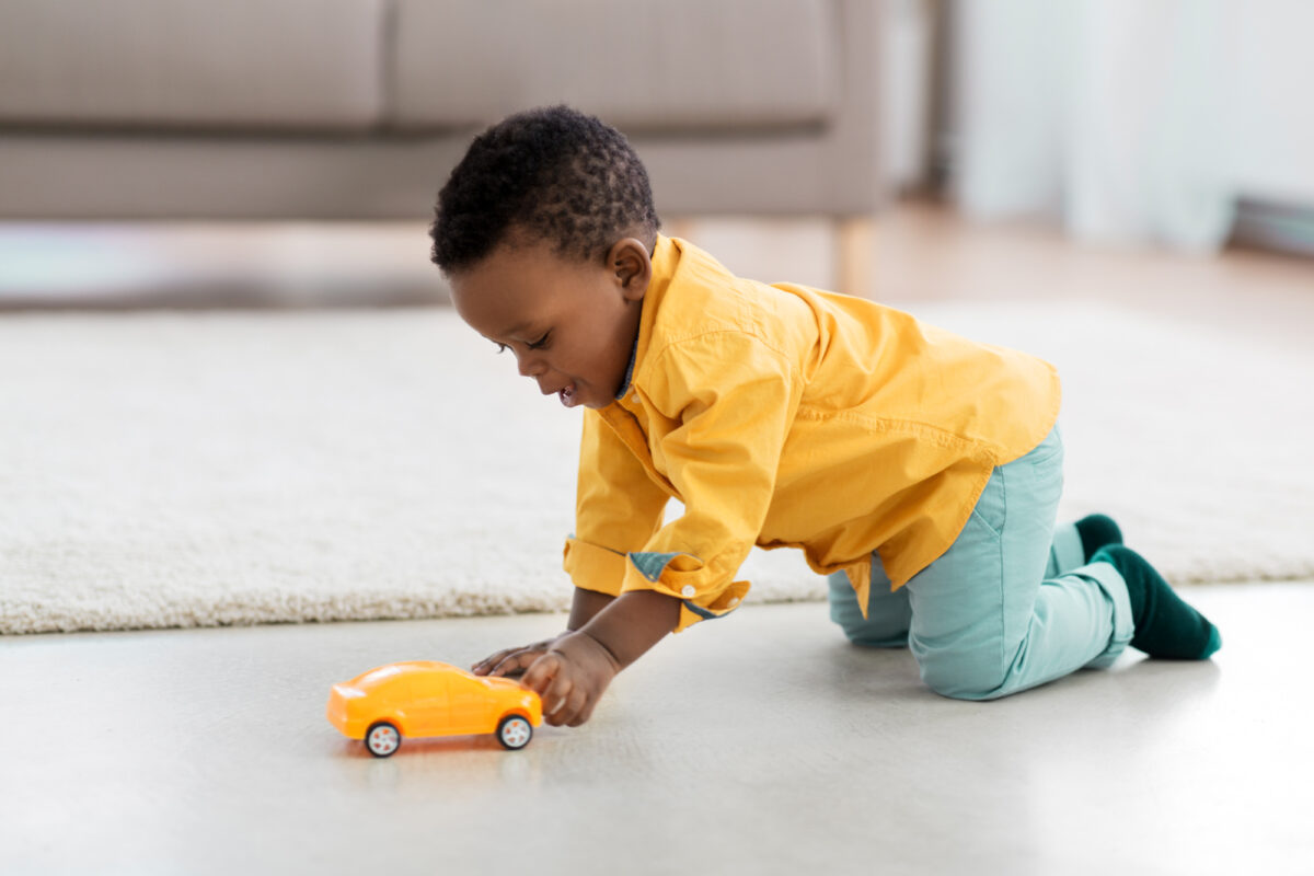 toddler playing with toy car