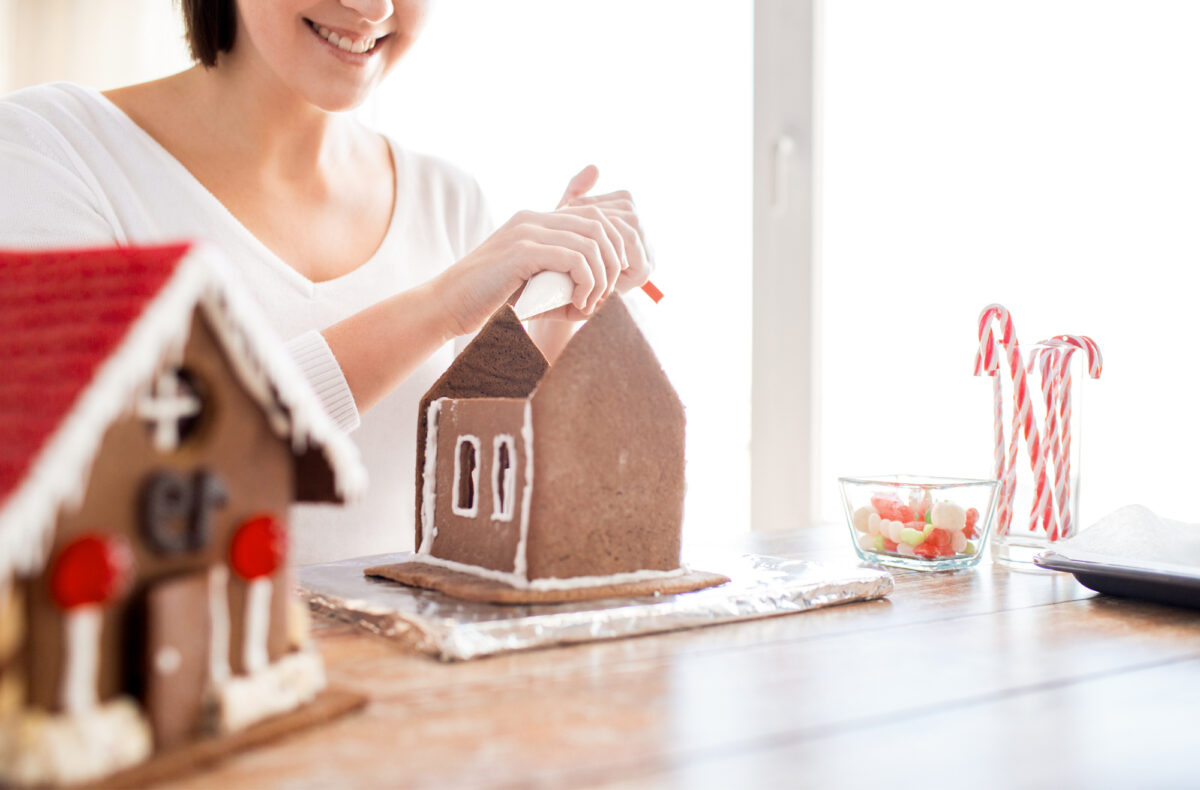 woman decorating gingerbread house