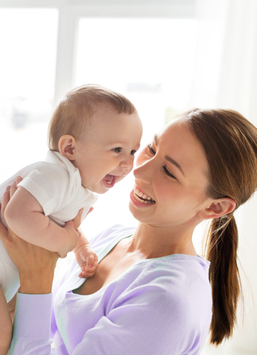 mom holding happy baby
