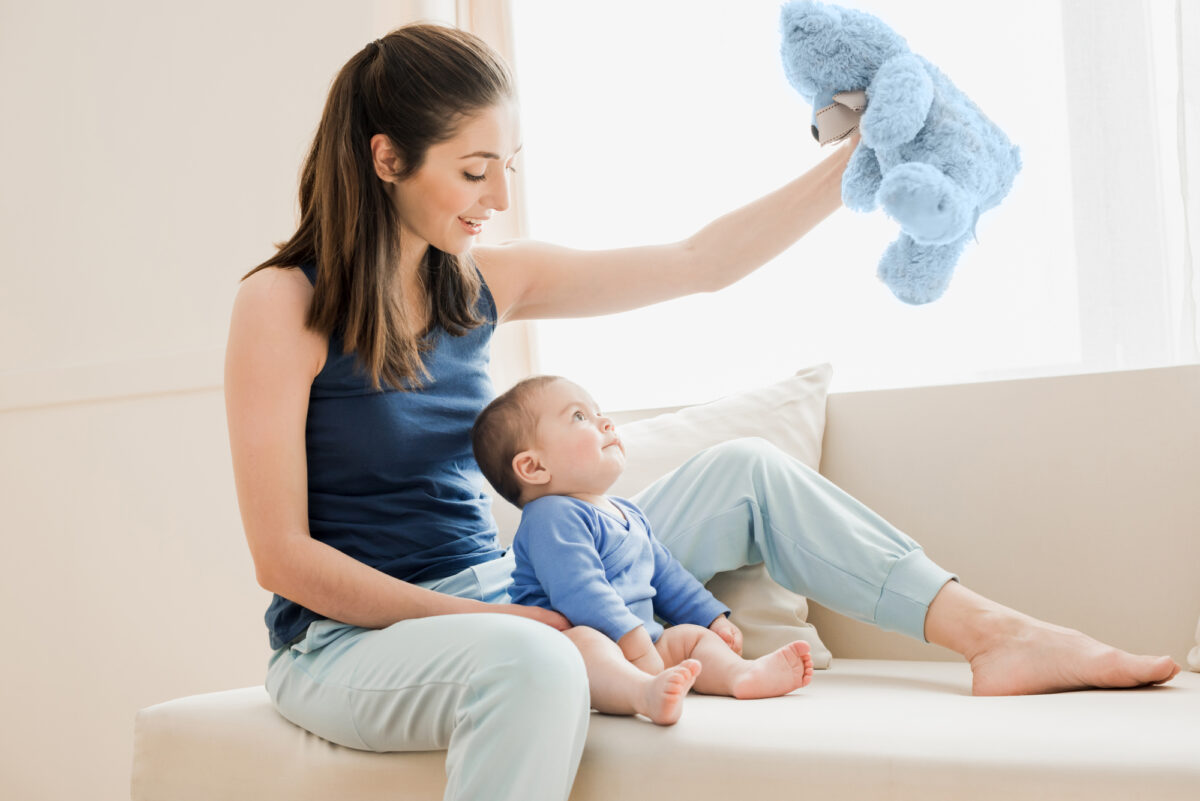 mom playing with 6 month old baby