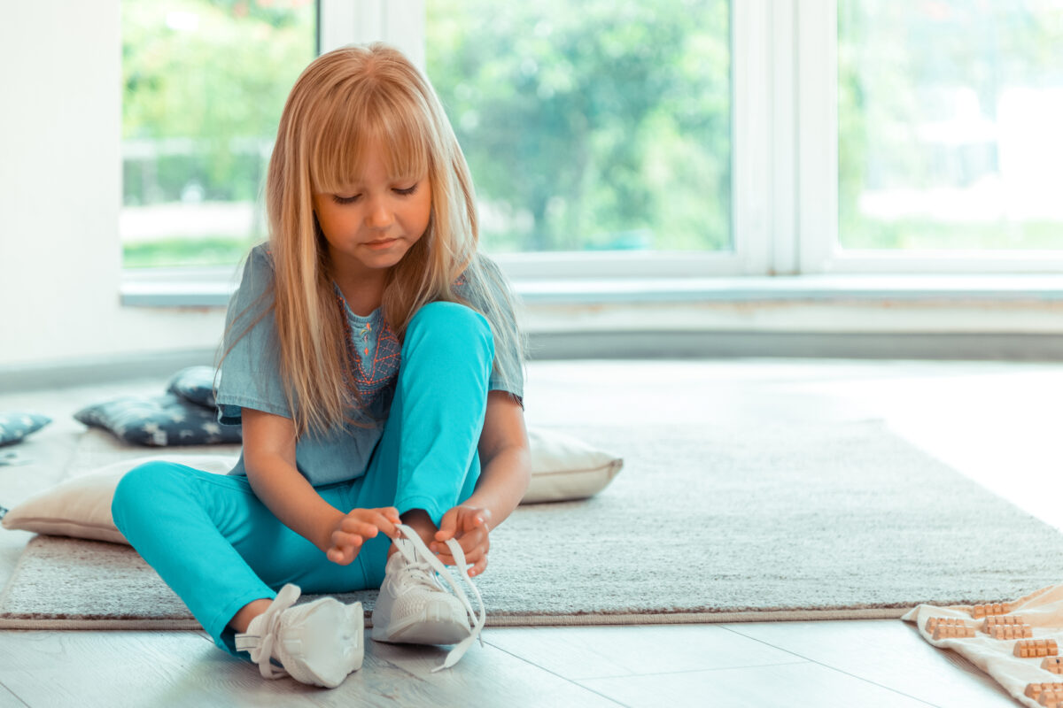 child putting on shoes