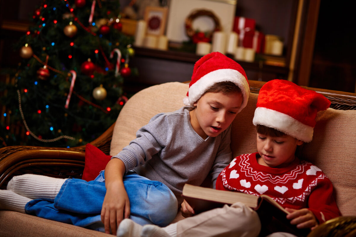 boys reading christmas book together