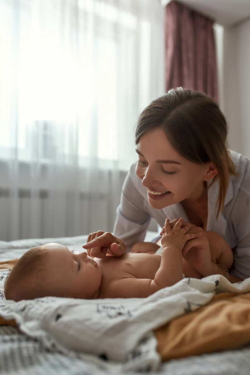 Mom giving baby massage as part of baby bedtime routine