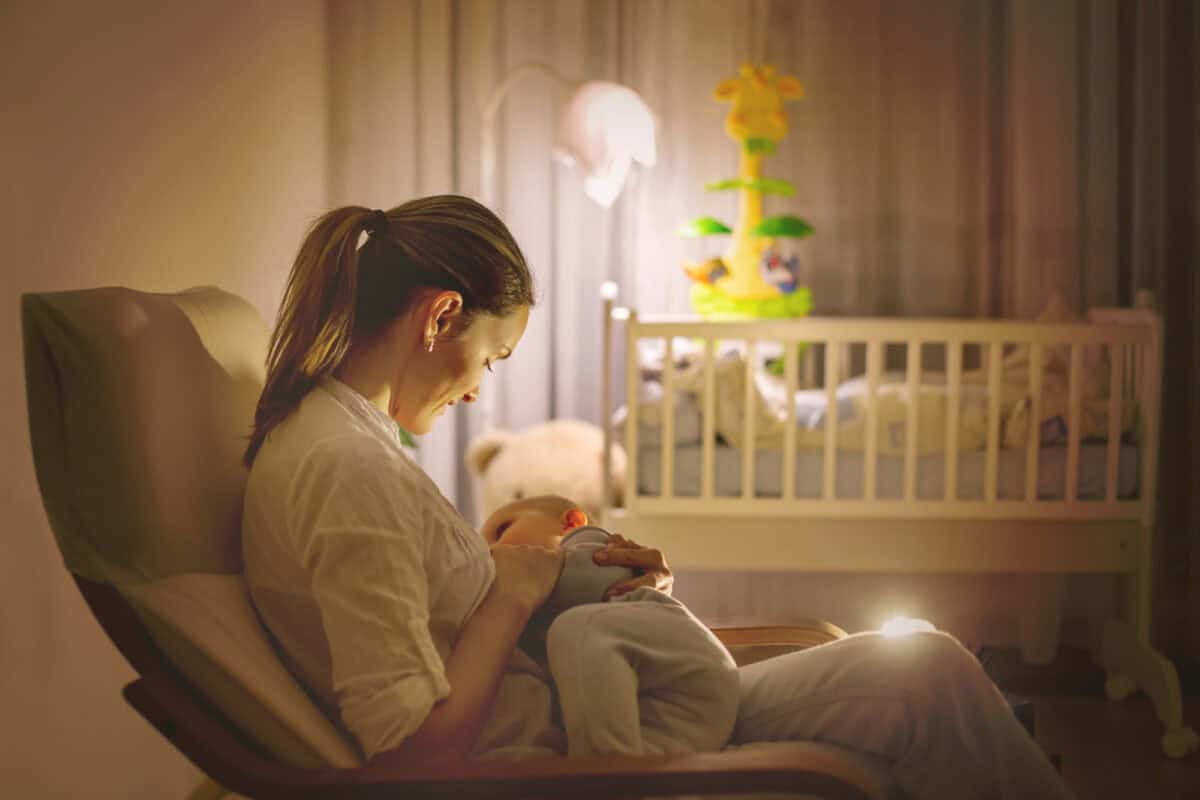 mom nursing baby at night
