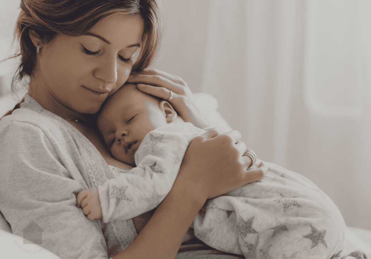 mom holding her sleeping baby