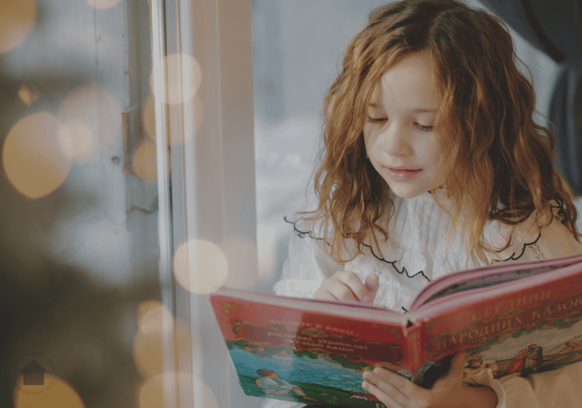 young girl reading christmas book