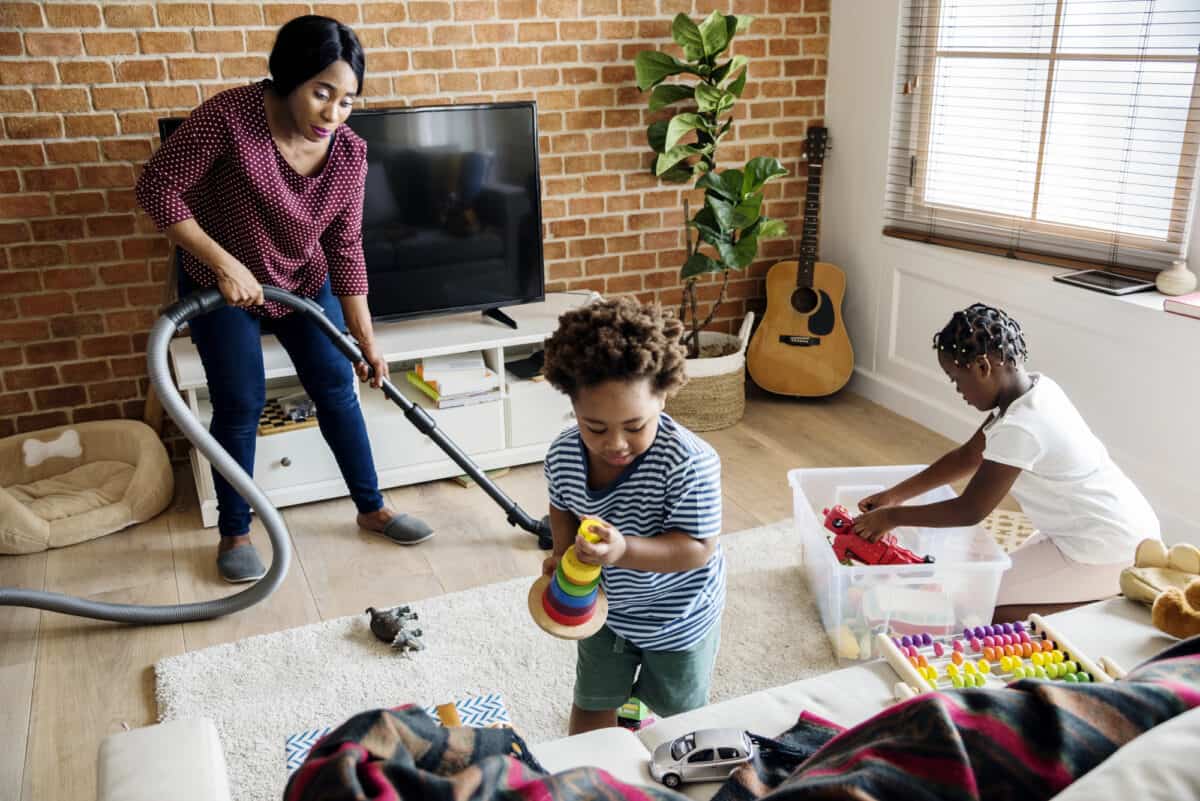 children helping mom clean up the living room