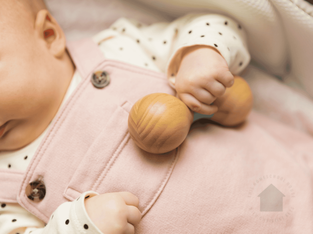 baby playing with rattle