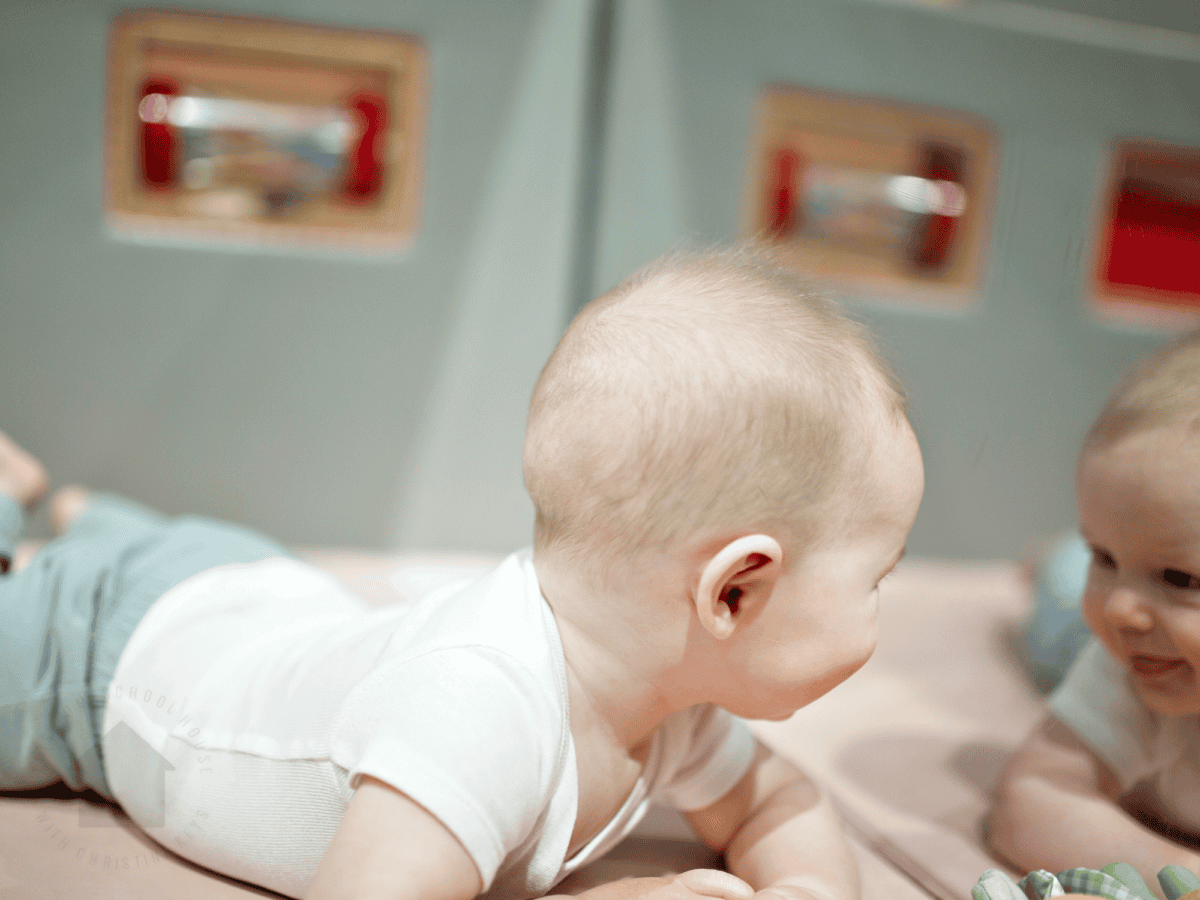 baby having tummy time with a mirror