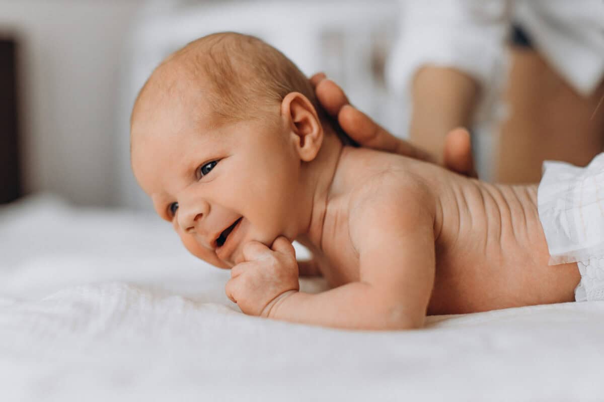 mom helping newborn do tummy time