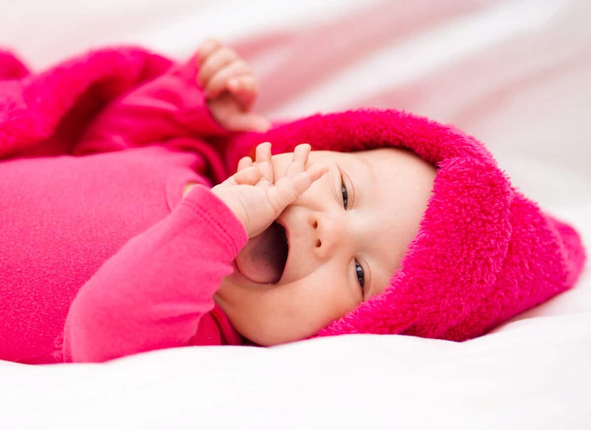 baby dressed in pink smiling