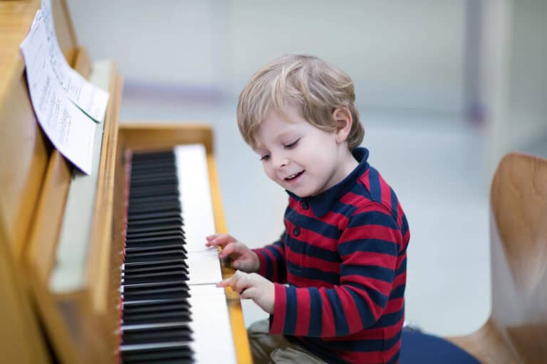 child learning piano as one of many homeschool music ideas