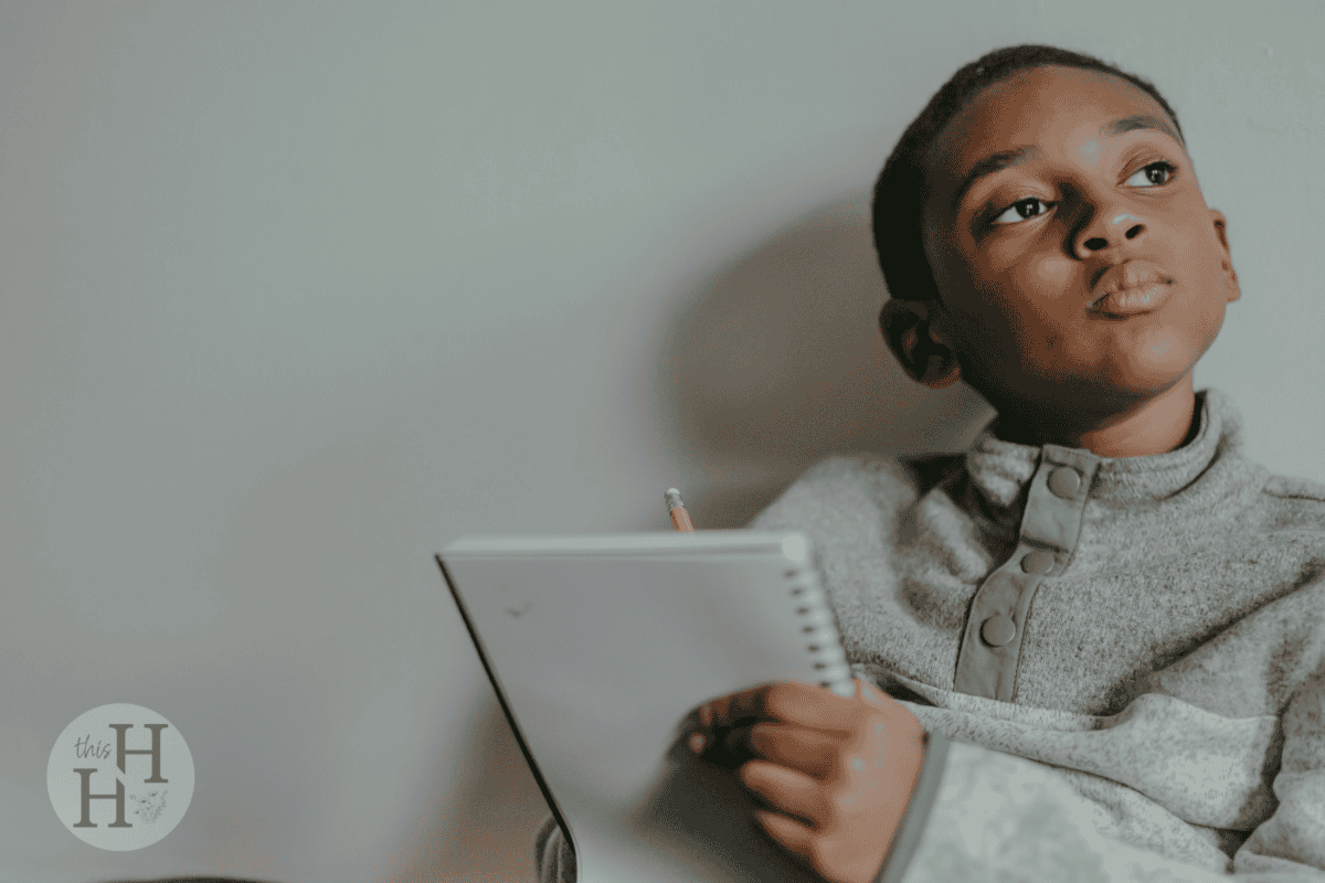 young boy with a notebook