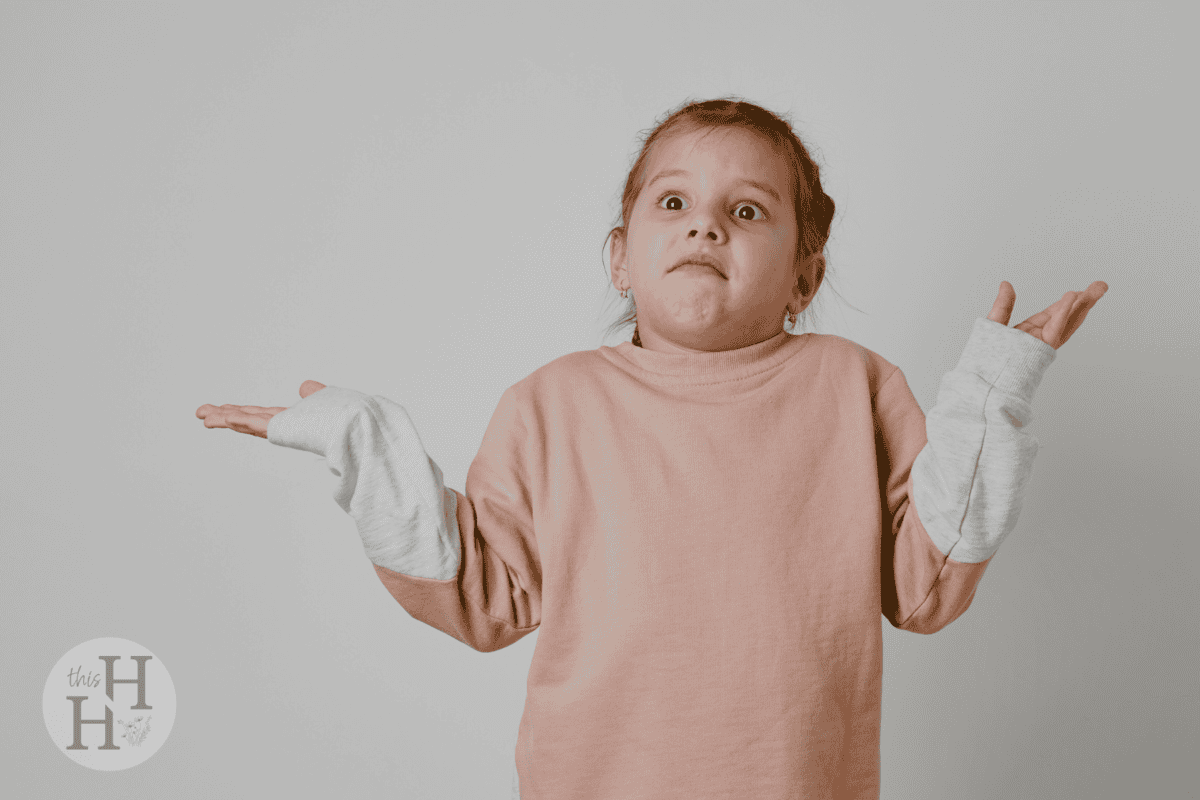 little girl wearing pink jumper