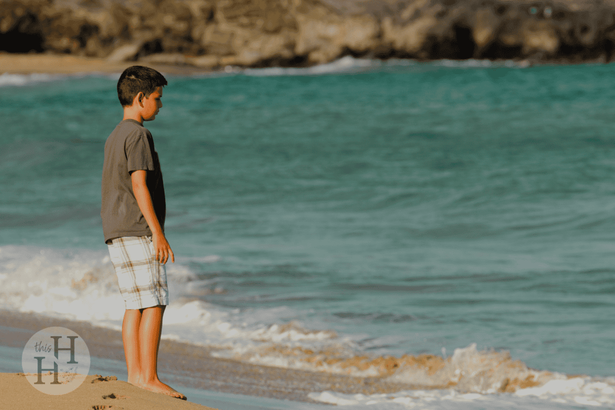 child observing the waves