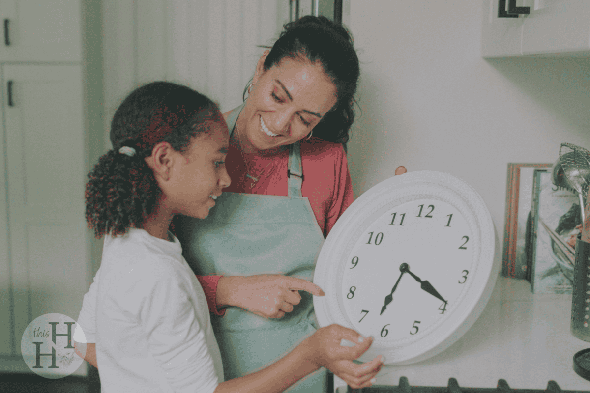 mom showing clock to daughter