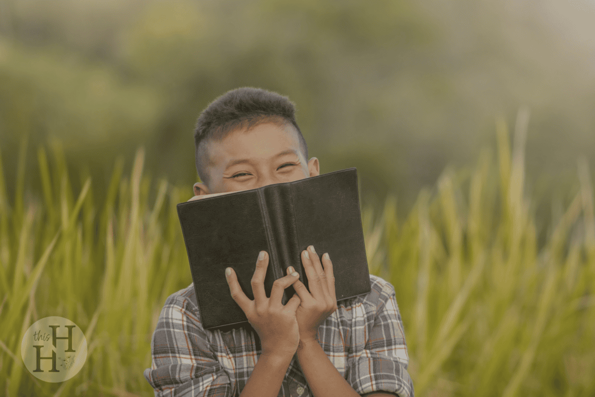 happy boy holding bible
