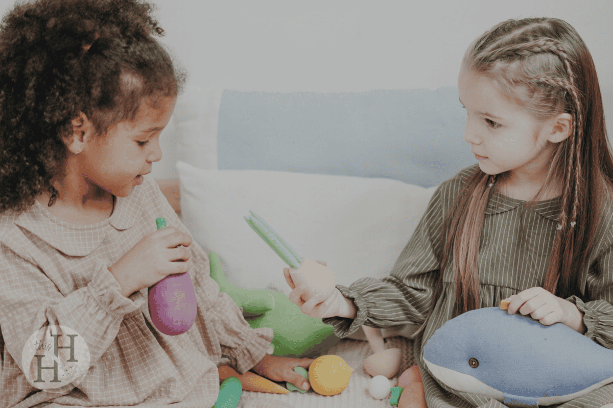 Young girls sharing toys