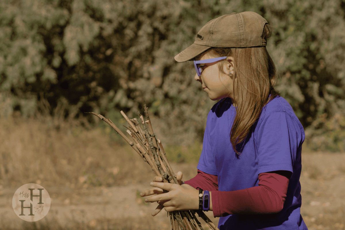 girl holding sticks