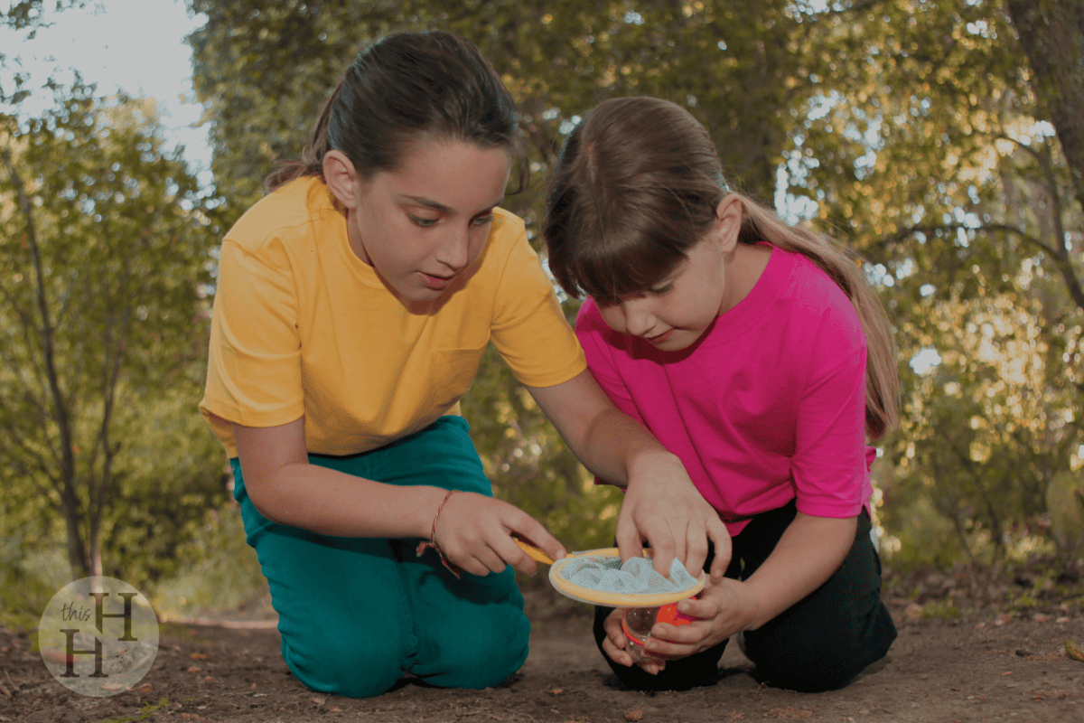 girls examining something in nature