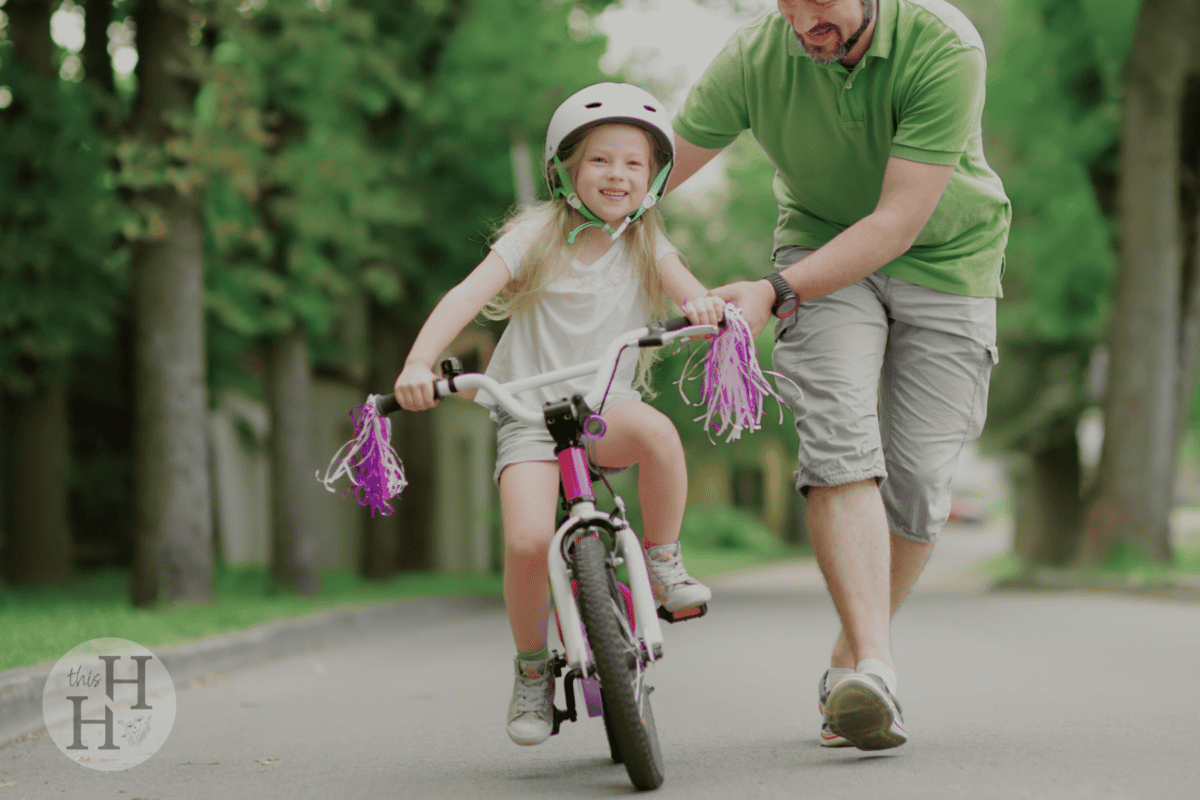 girl learning to ride her bike