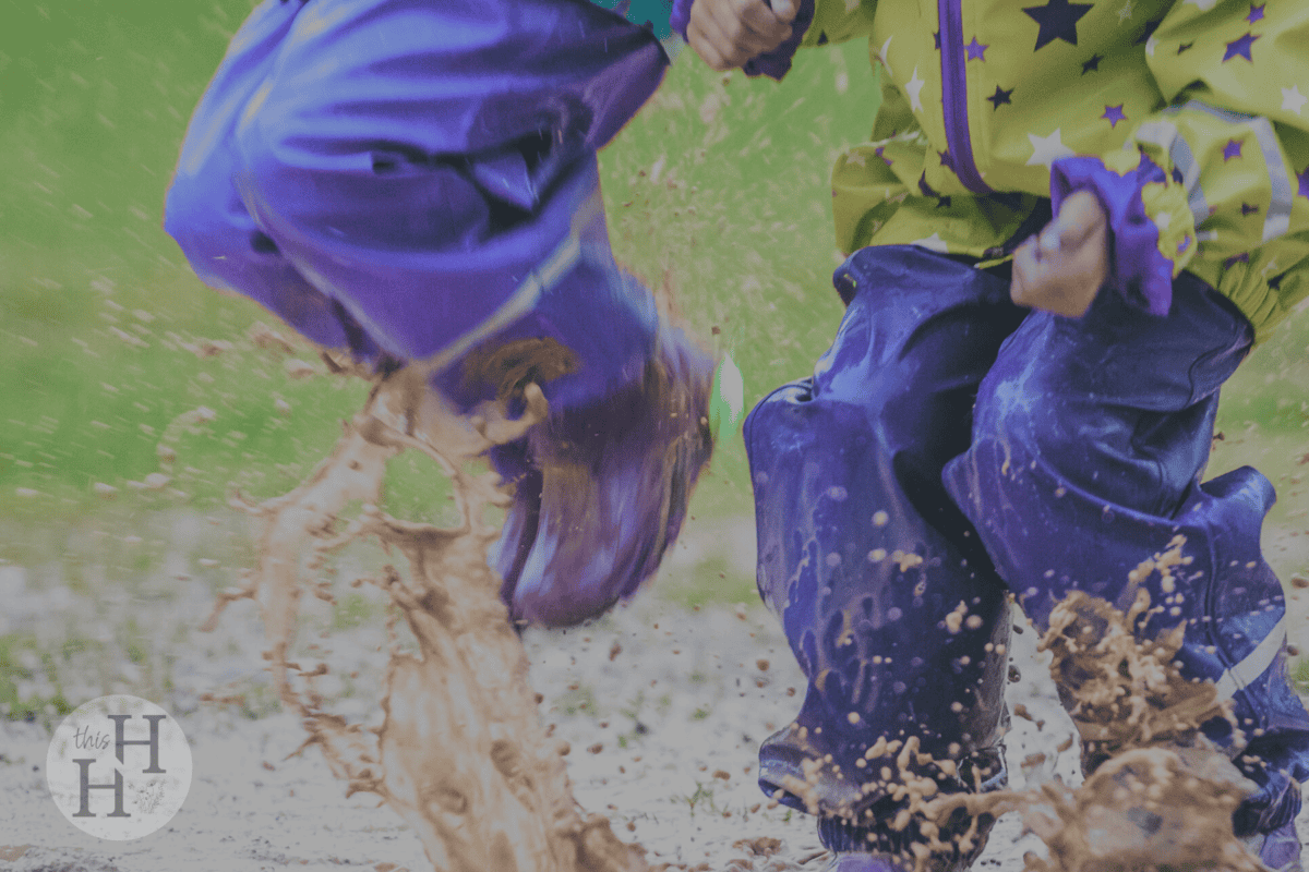 kids jumping in puddle