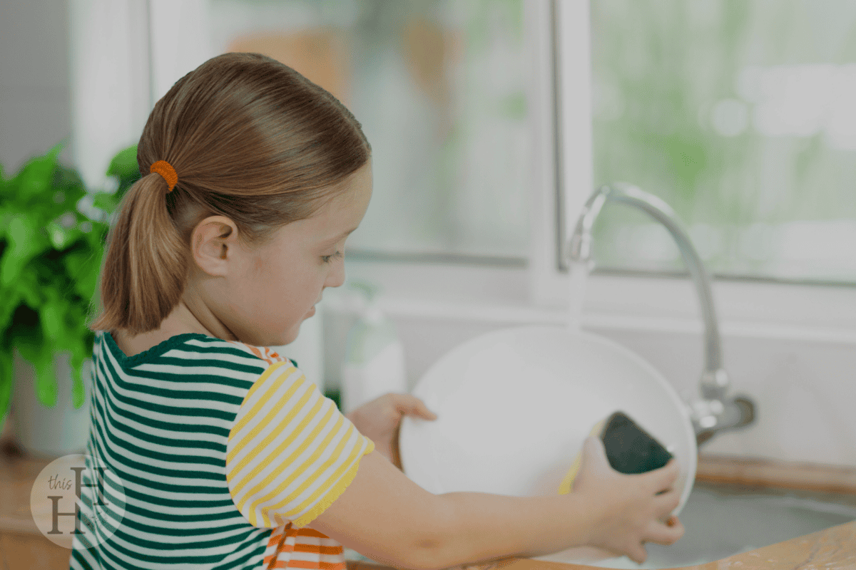 little girl washing dishes