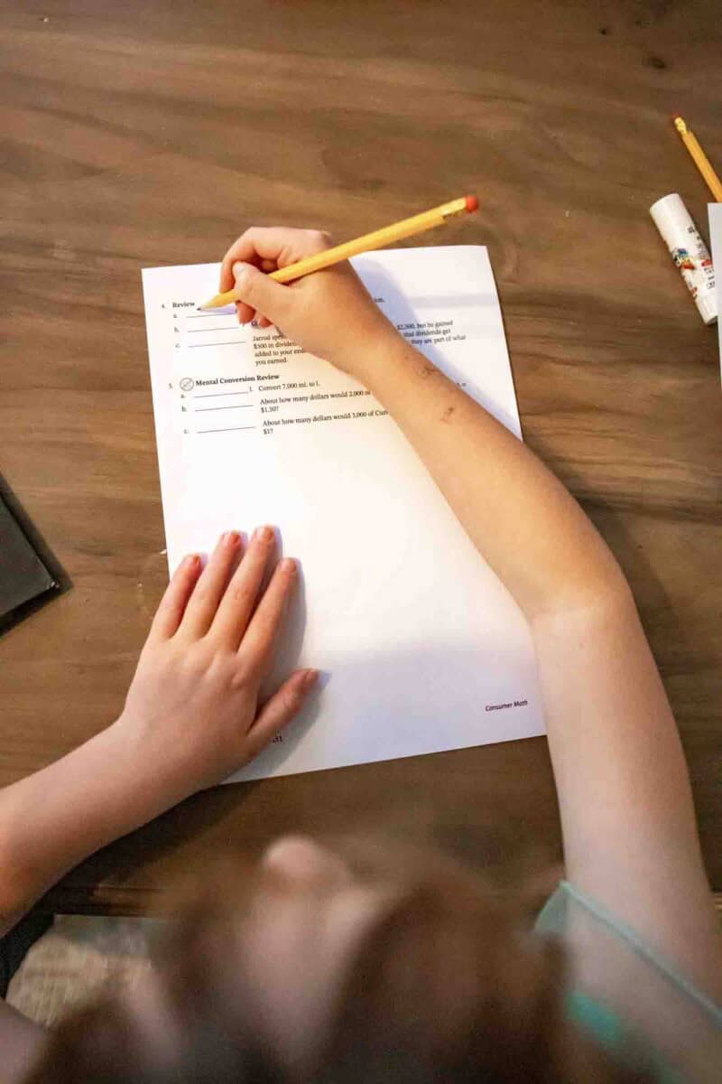 child using consumer math book