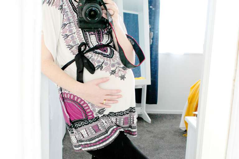 36 Week Pregnancy Update: Early Labour Signs. Pregnant woman standing in front of mirror.