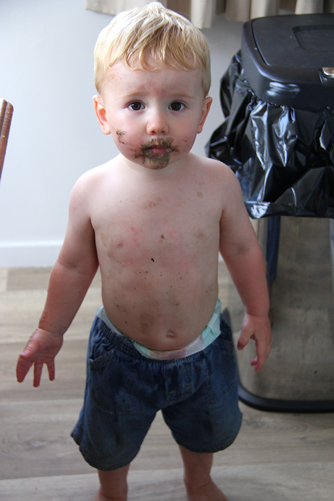 toddler covered in mud