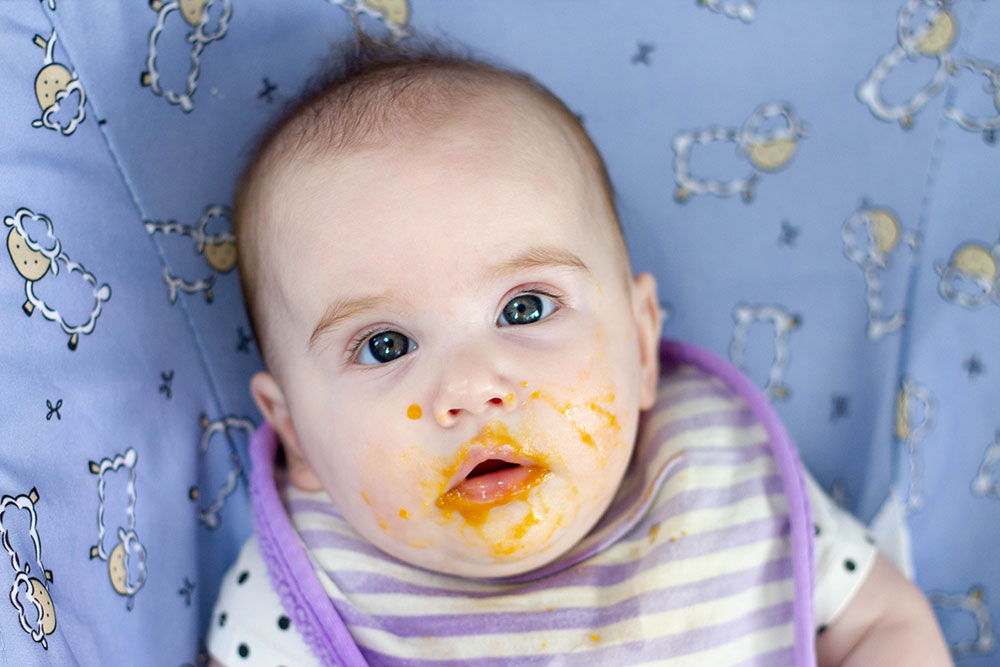 5 month old baby with food on her face