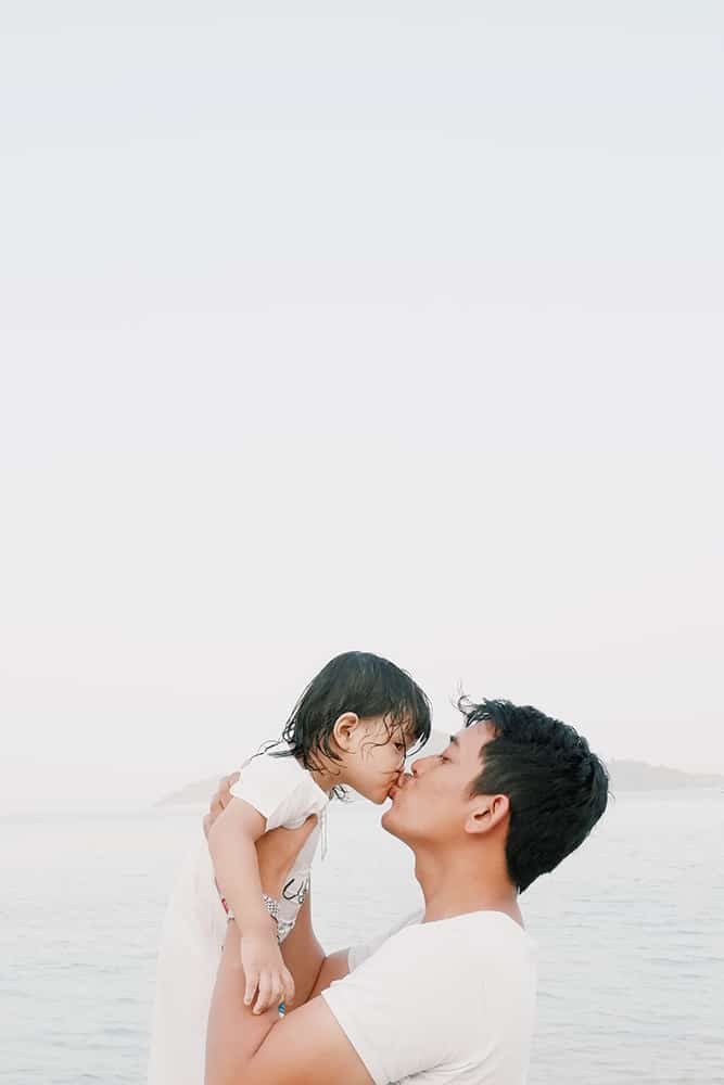 Dad kissing daughter
